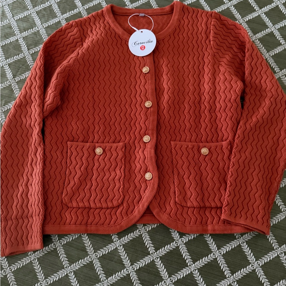 Adorable cardigan with buttons and pockets. Size medium.